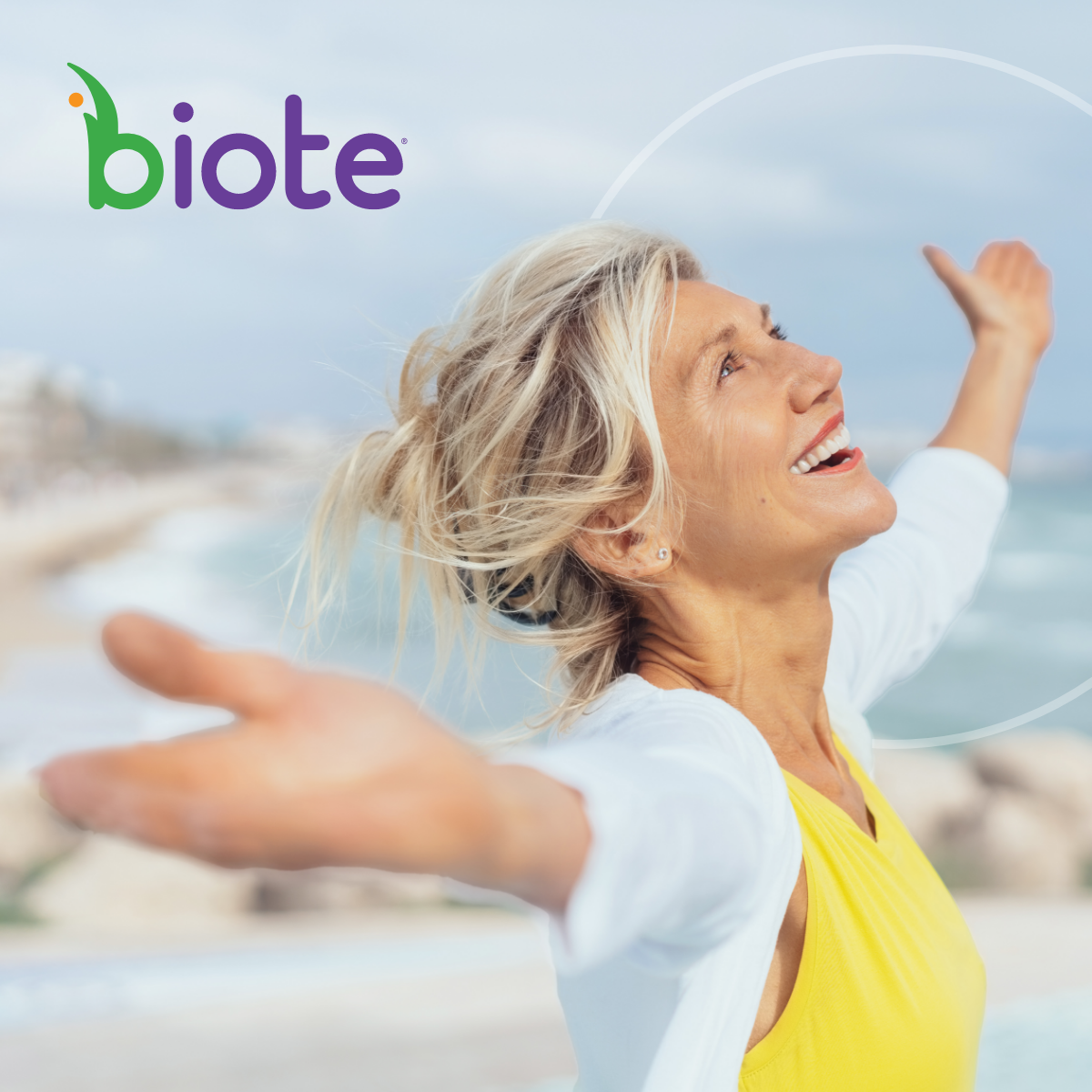 Woman on a beach with arms out happy